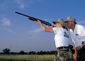 Instructor and student skeet shooting