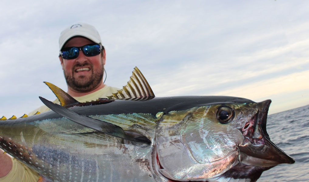 Fisherman holding a large tuna
